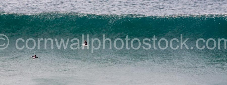 Surfers About To Duck Massive Wave