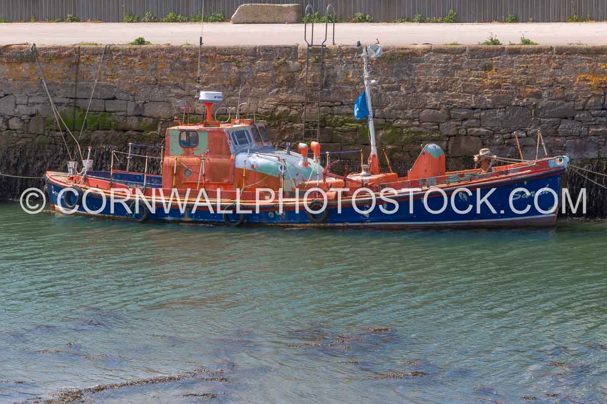 Vintage Lifeboat Against Harbour Wall